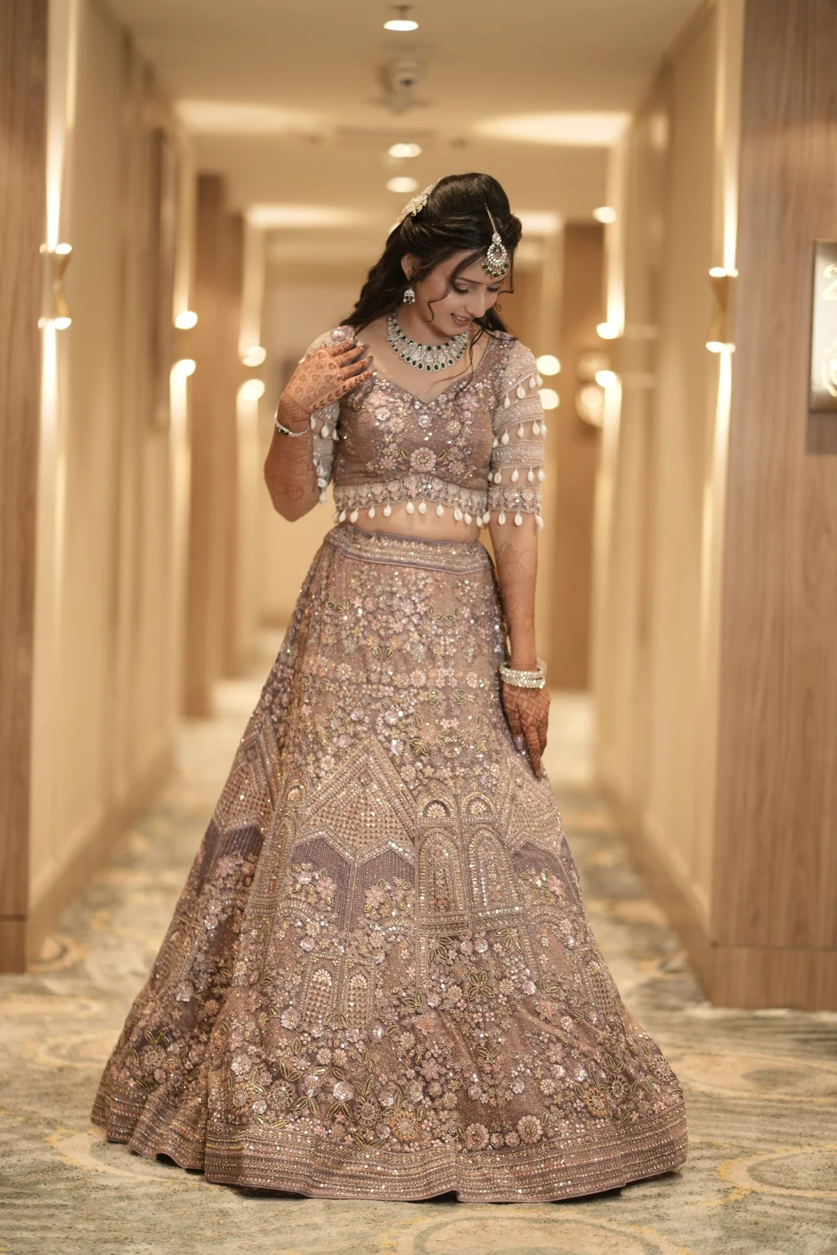 Candid bridal moment in a mauve lehenga