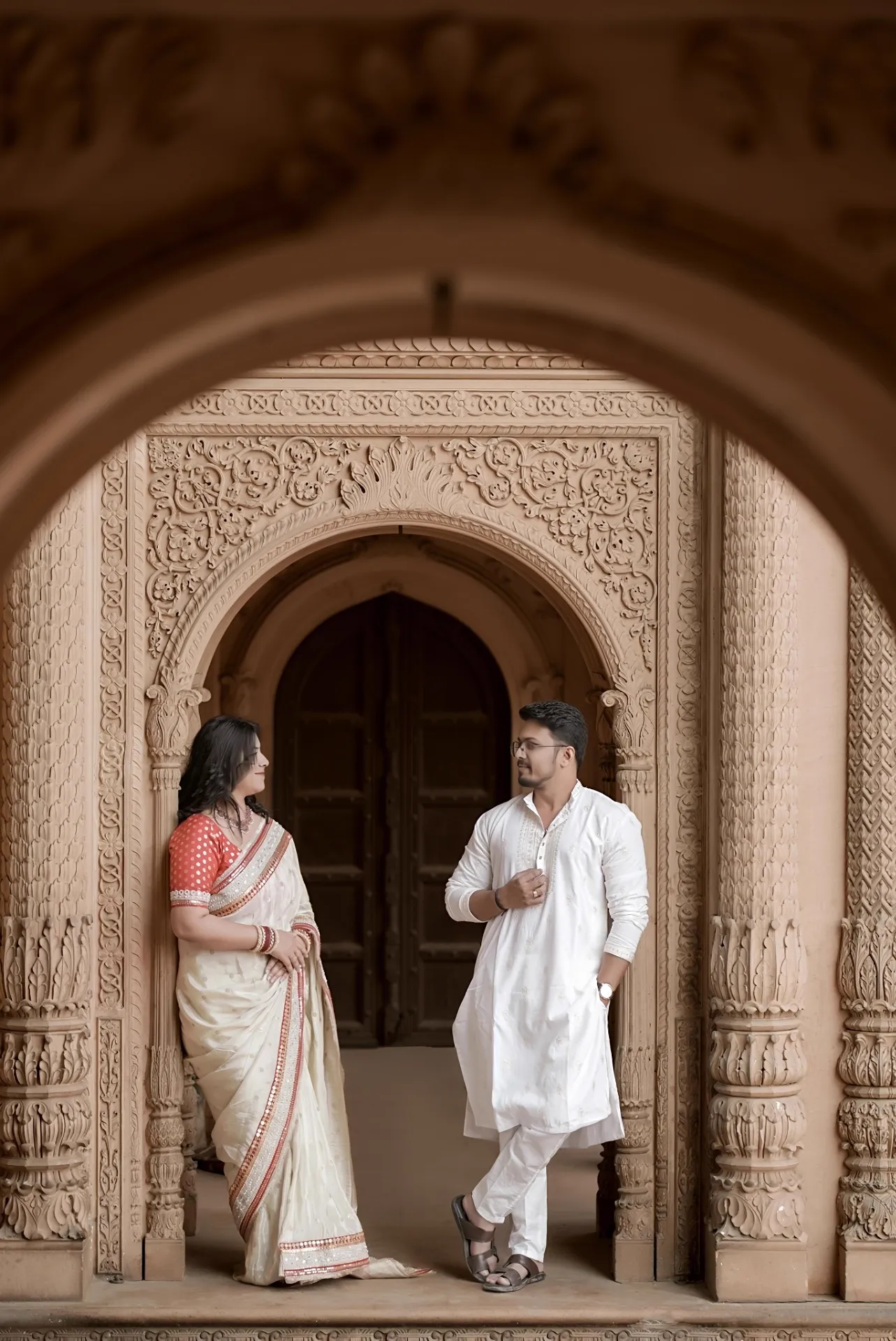 Pre-wedding portrait framed by a heritage archway