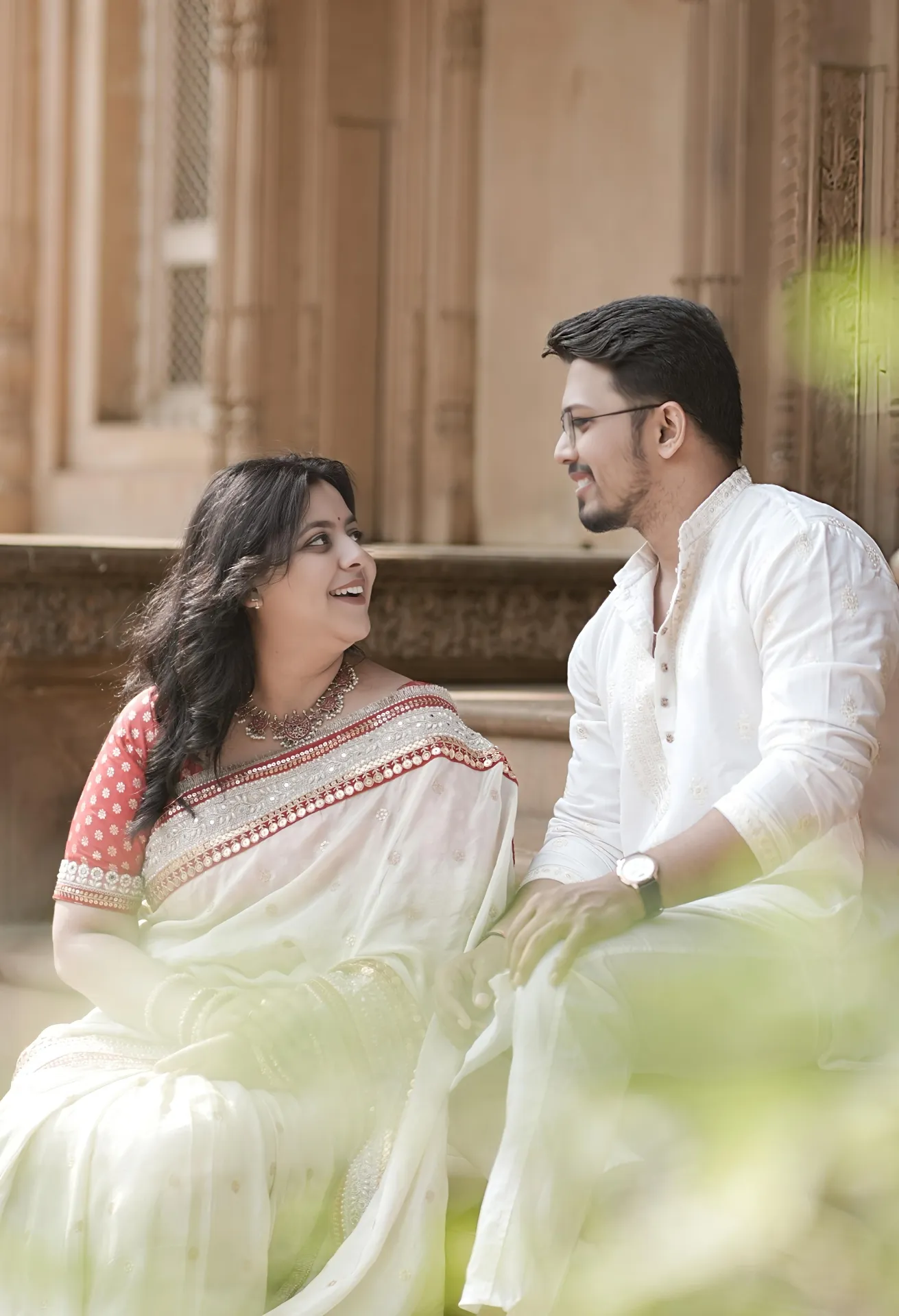 Candid pre-wedding moment of the couple sharing a laugh